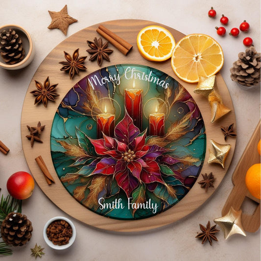 Round glass cutting board with a vibrant Christmas design featuring three glowing red candles and a large poinsettia flower. Text reads “Merry Christmas” at the top and is customisable at the bottom with a family name or person’s name, like “Smith Family”.