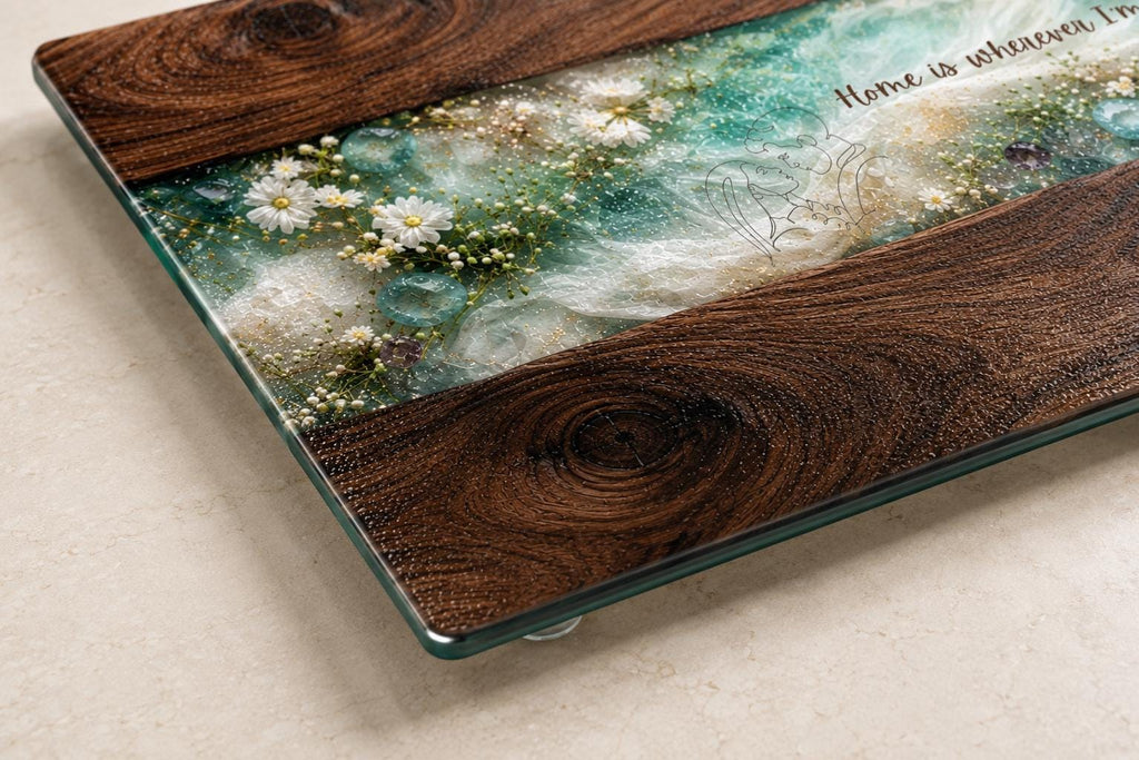 Close-up of personalised glass chopping board with dark wood effect, turquoise resin-style centre, white wildflowers and decorative crystals, showing detailed glass texture and polished edges.